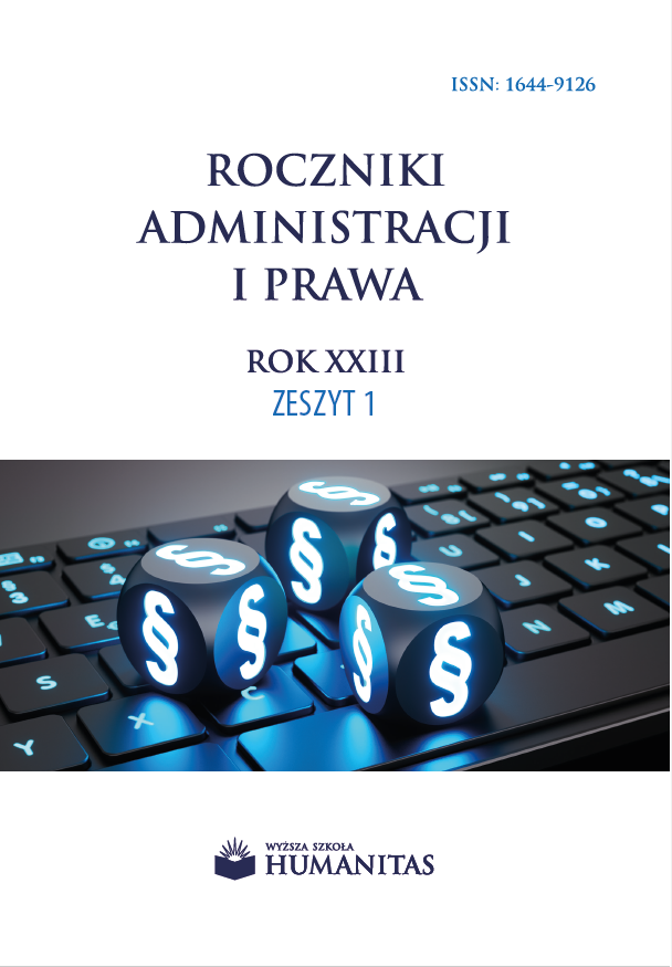 Okładka czasopisma naukowego przedstawia klawiaturę komputerową, na której umieszczono podświetlone symbole paragrafu. Grafika nawiązuje do prawa, administracji oraz cyfrowego kontekstu funkcjonowania systemu prawnego. Na okładce widnieje tytuł „Roczniki Administracji i Prawa”, oraz numer tomu: 1/XXIII. U dołu znajduje się logo i nazwa wydawcy – Akademia Humanitas.